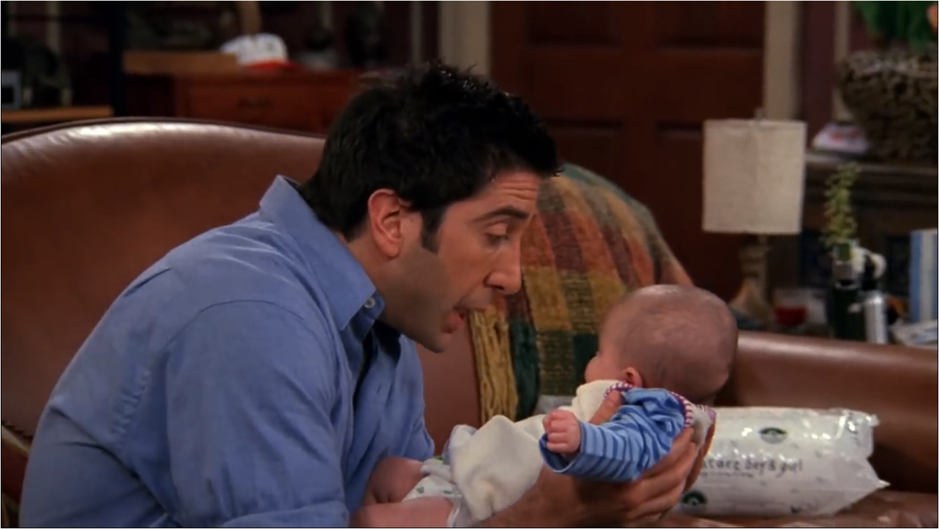 Ross holding baby emma in his hands